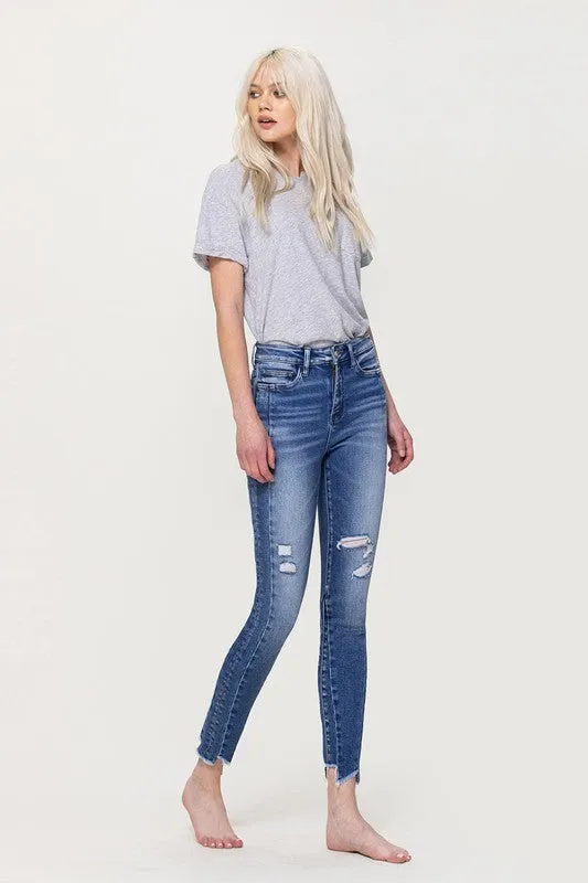 HIGH RISE ANKLE SKINNY W UNEVEN HEM DETAIL